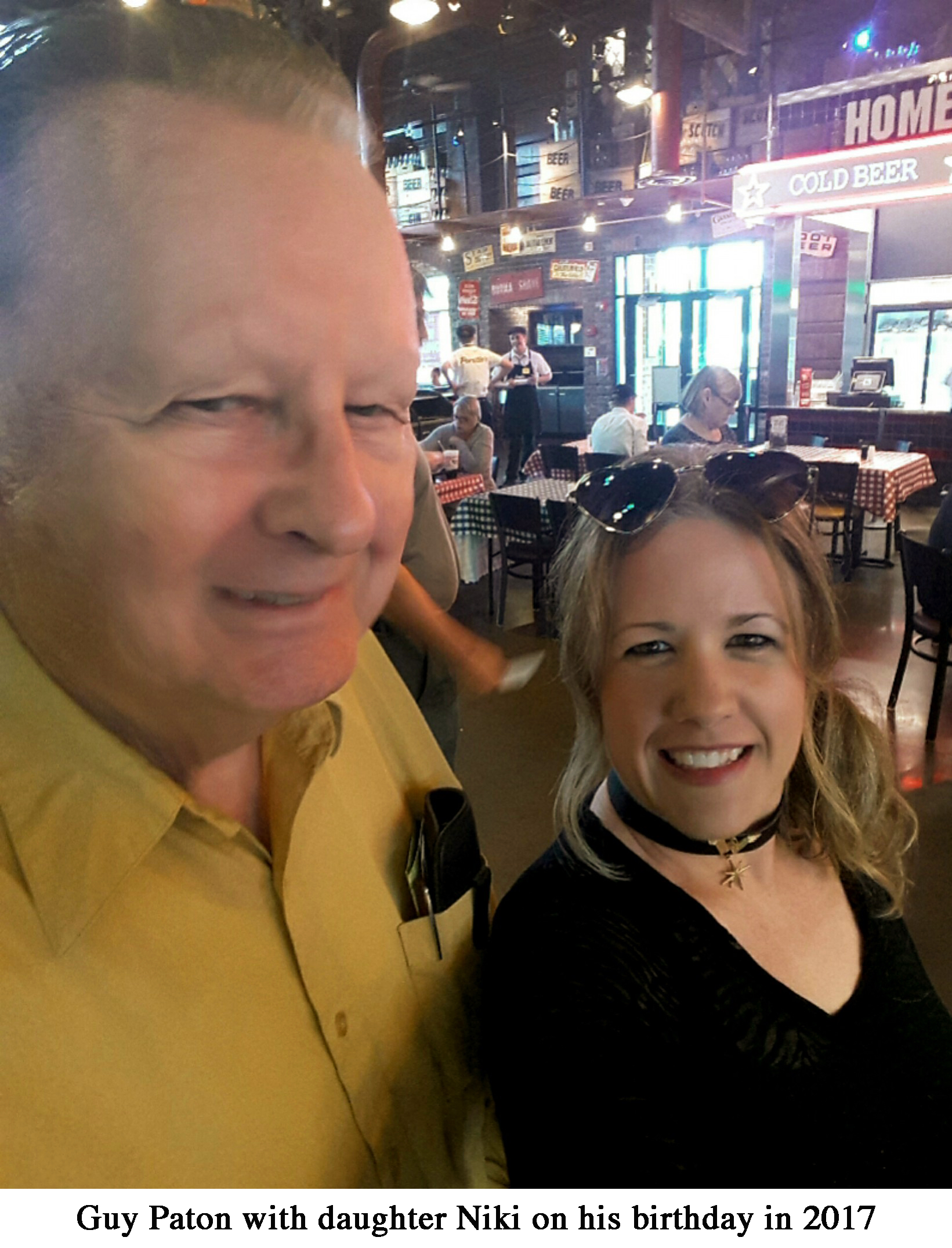 A selfie by Guy Paton with his daughter Niki by his side in the dining room
            of a restaurant