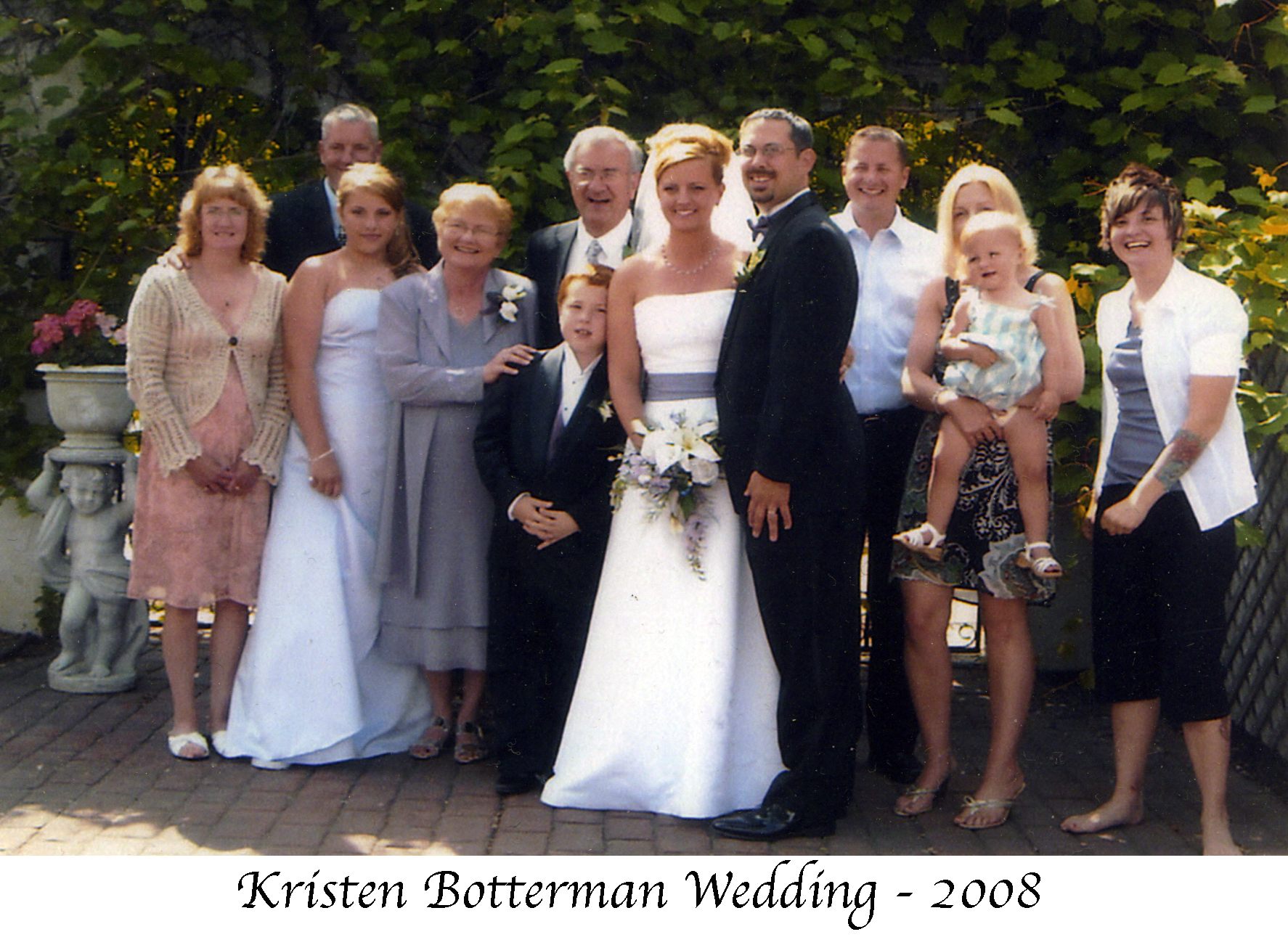 Bride and groom with the bride’s family on a patio