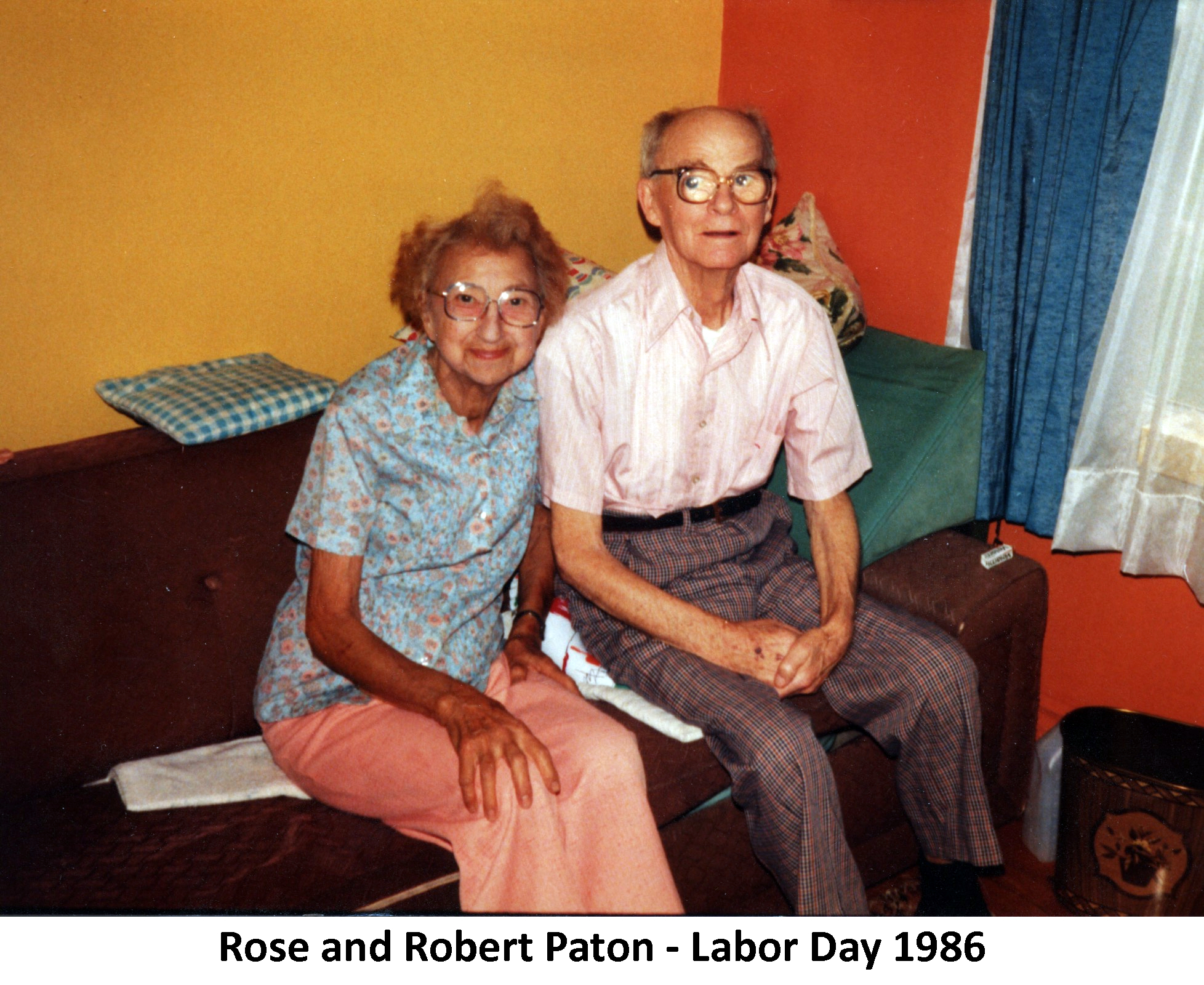 Rose and Bob Paton are sitting together in a room in their home.
               They are looking at the camera.