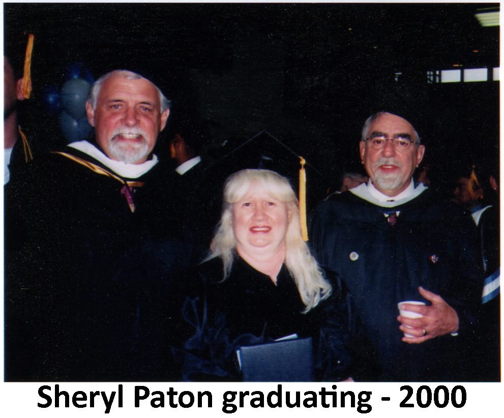 Sheryl Paton wearing her cap and gown at her college graduation and 
         standing between two of her professors, both bearded.