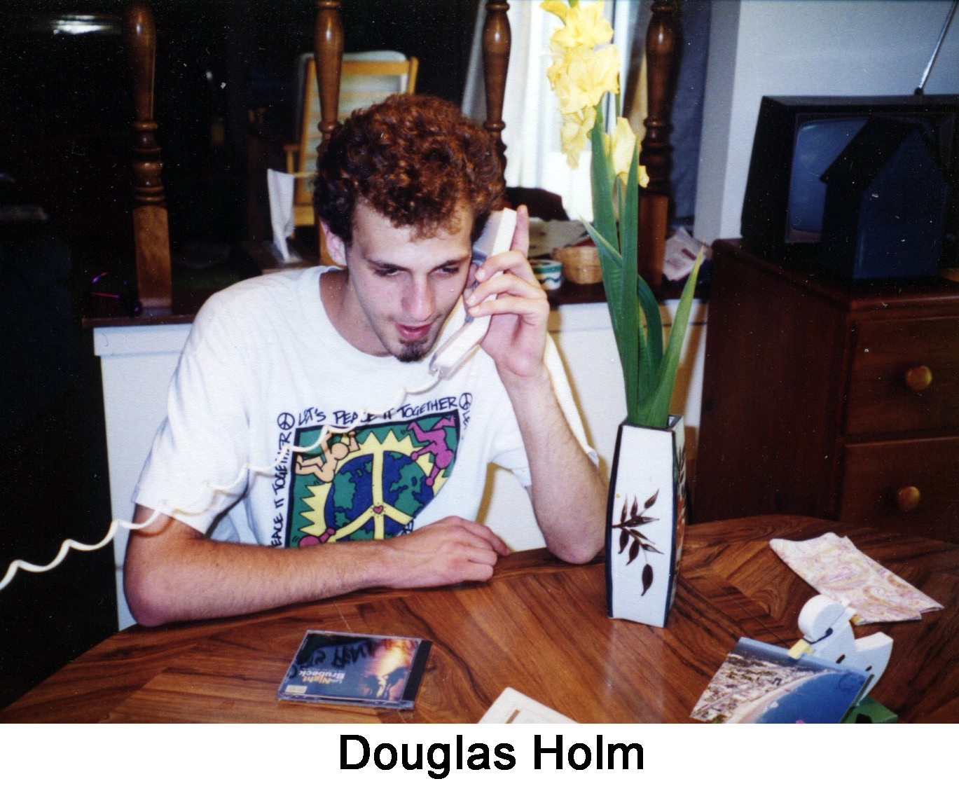 Doug Holm is sitting at the dinner table with phone in hand