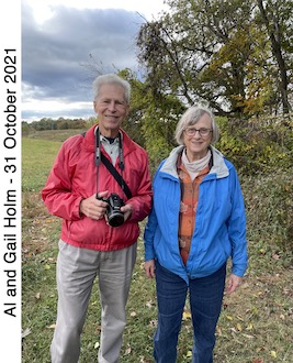 Al and Gail Holm standing near a tree with a field behind them.