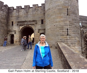 Gail Holm standing at the gate to Sterling Castle, Scotland