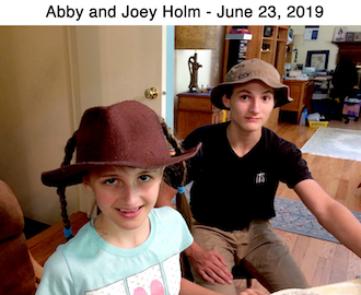 Abigail and Joseph Holm wearing hats and looking at camera