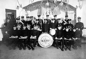 Members of the band are in three rows; Fred Henjes sits in the front row