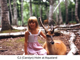 Carolyn Holm petting a deer at Aqualand