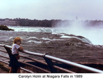 Carolyn Holm standing at the railing by the Niagra River where it flows                 over the falls