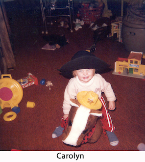 Cowgirl baby Carolyn on a stuffed horse in our rec room in 1982