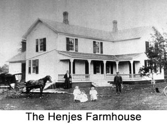 A large two story building with a woman, a man, and three
               girls in front of it, and a horse and buggy to the side.