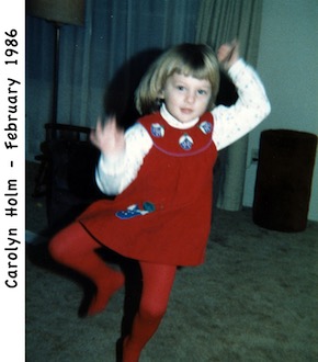 Carolyn Holm dancing in our living room in a red dress and red tights