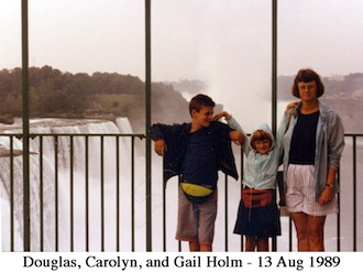 Douglas, Carolyn, and Gail standing by the railing with the falls in the background