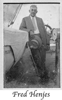 Fred Henjes standing on a ship and leaning against a lifeboat