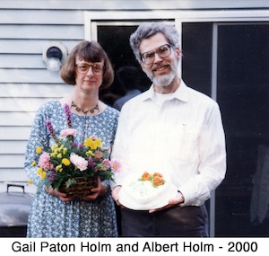 Gail Paton and Albert Holm celebrating their 25th anniversary 
          with flowers and a cake.