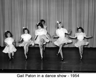 8-year-old Gail Paton kicking up a leg with other dancers on stage 