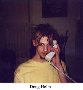 Polaroid snapshot of Doug with dreads and on the phone