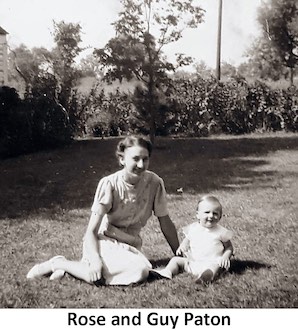 Rose Paton with her infant son Guy sitting on a lawn