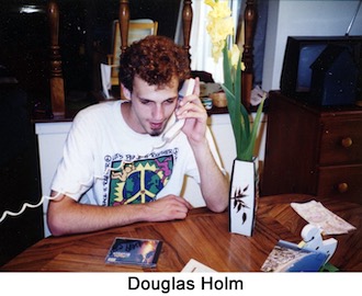 Doug Holm is sitting at the dinner table with phone in hand