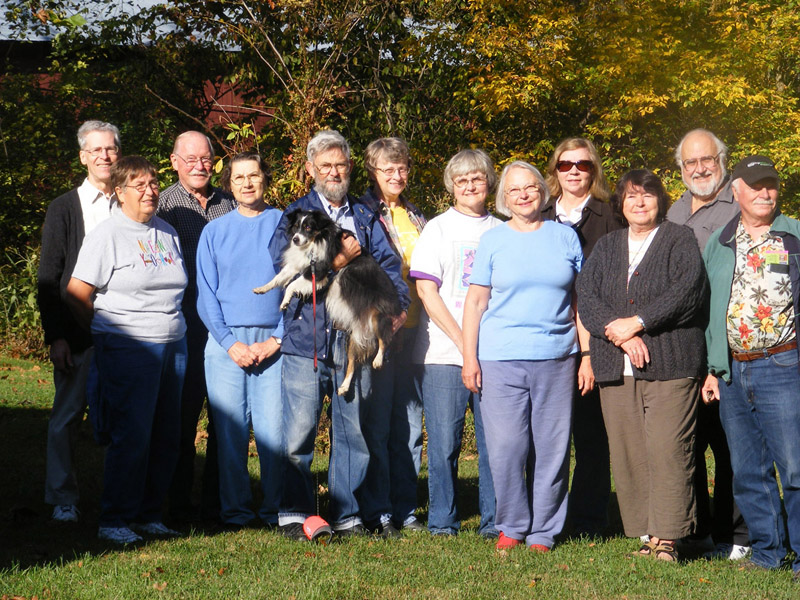 The whole group in the backyard 
of the Guesthouse with the 
covered bridge in the trees behind them
