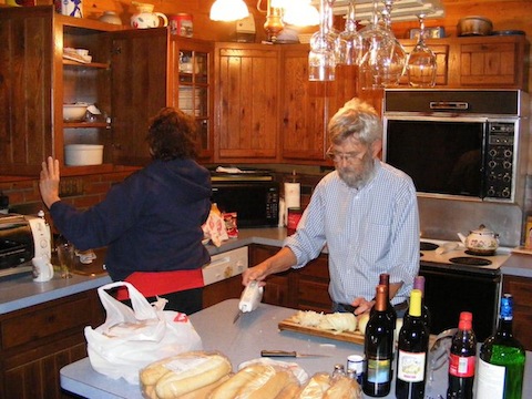 Bill slices onions in the kitchen