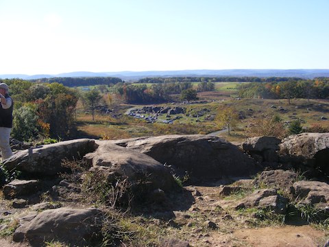Devil's Den seen from
          the Union positions on Little Round Top. The small size of the
          cars shows the distance.