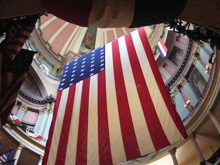 A large flag hangs
     down in the middle of the space. The dome and the balconies
     around it are each painted in different pastel colors