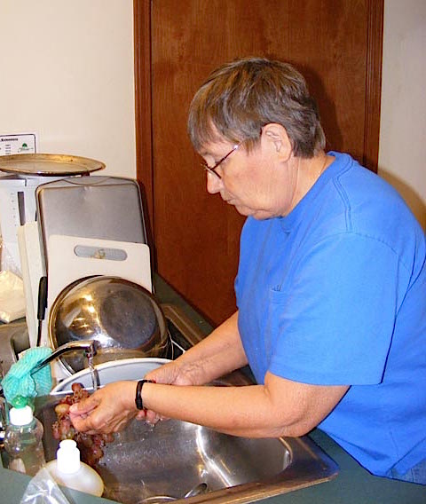 Maija washes grapes for her Saturday breakfast fruit salad