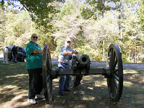 Bob Bower pretends to light the fuse 
             of one of the cannon in Fort Donelson