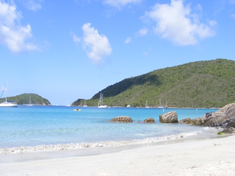 The campground beach at 
           Little Maho Bay, looking east past the rocks marking the 
           end of the bay and looking over Francis Bay beyond