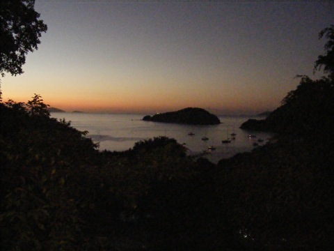 A view of
the bay from the restaurant's pavilion showing boats tied up for the night
and the colored sky
