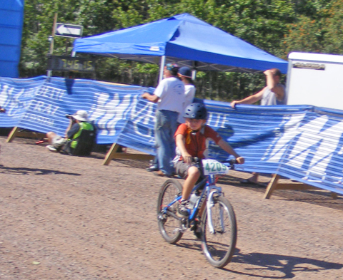 Caden rides past the finish line